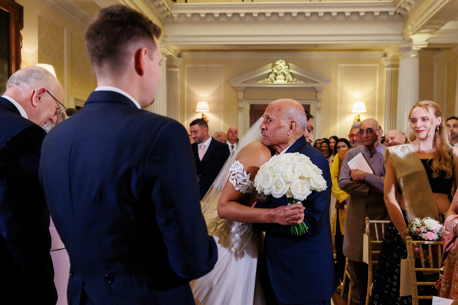 Bride's grandfather staring at groom
