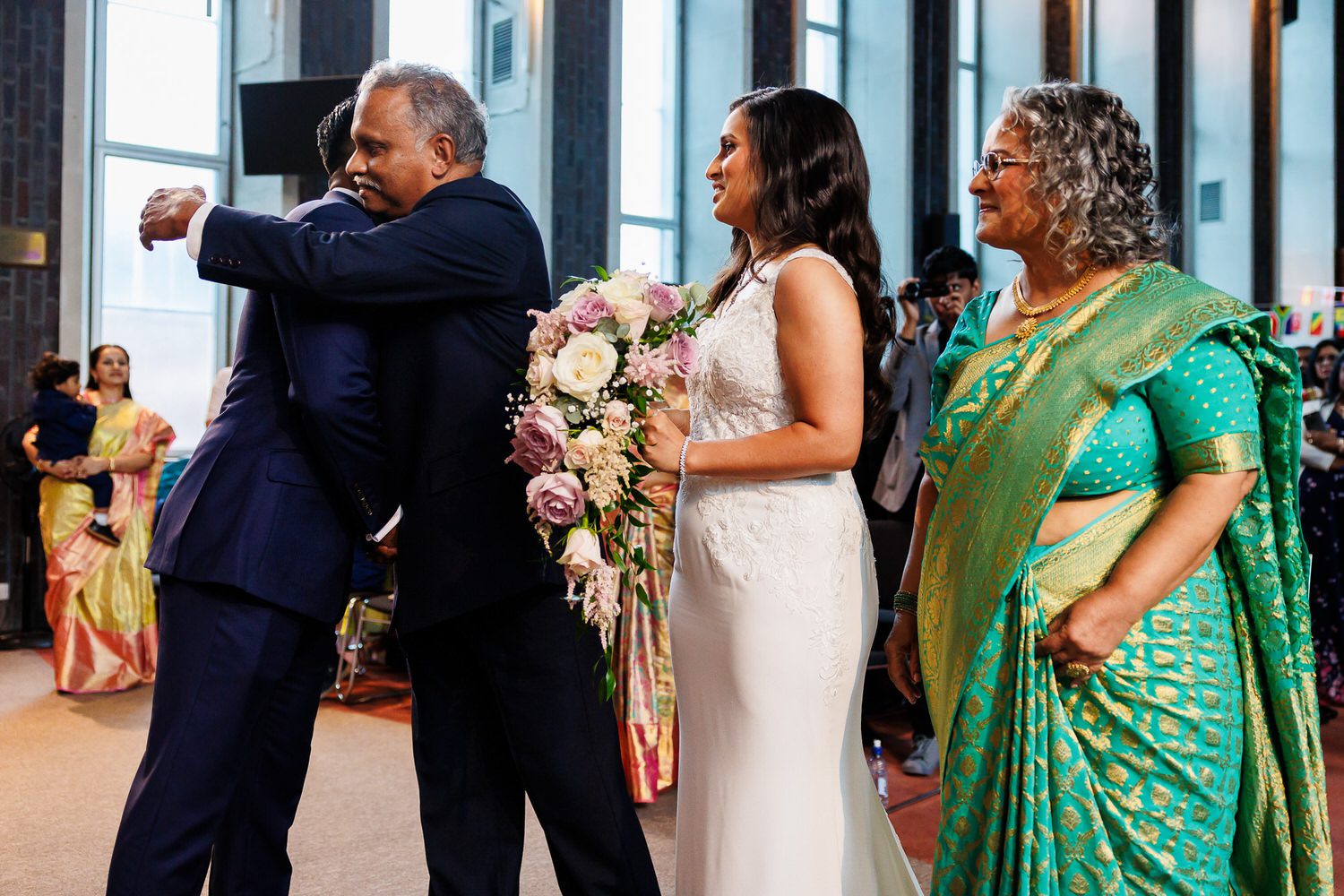 Father of Bride hugging Groom