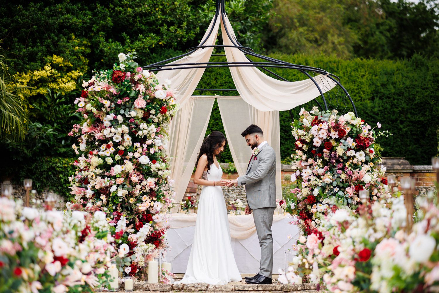 Bride putting wedding ring on groom