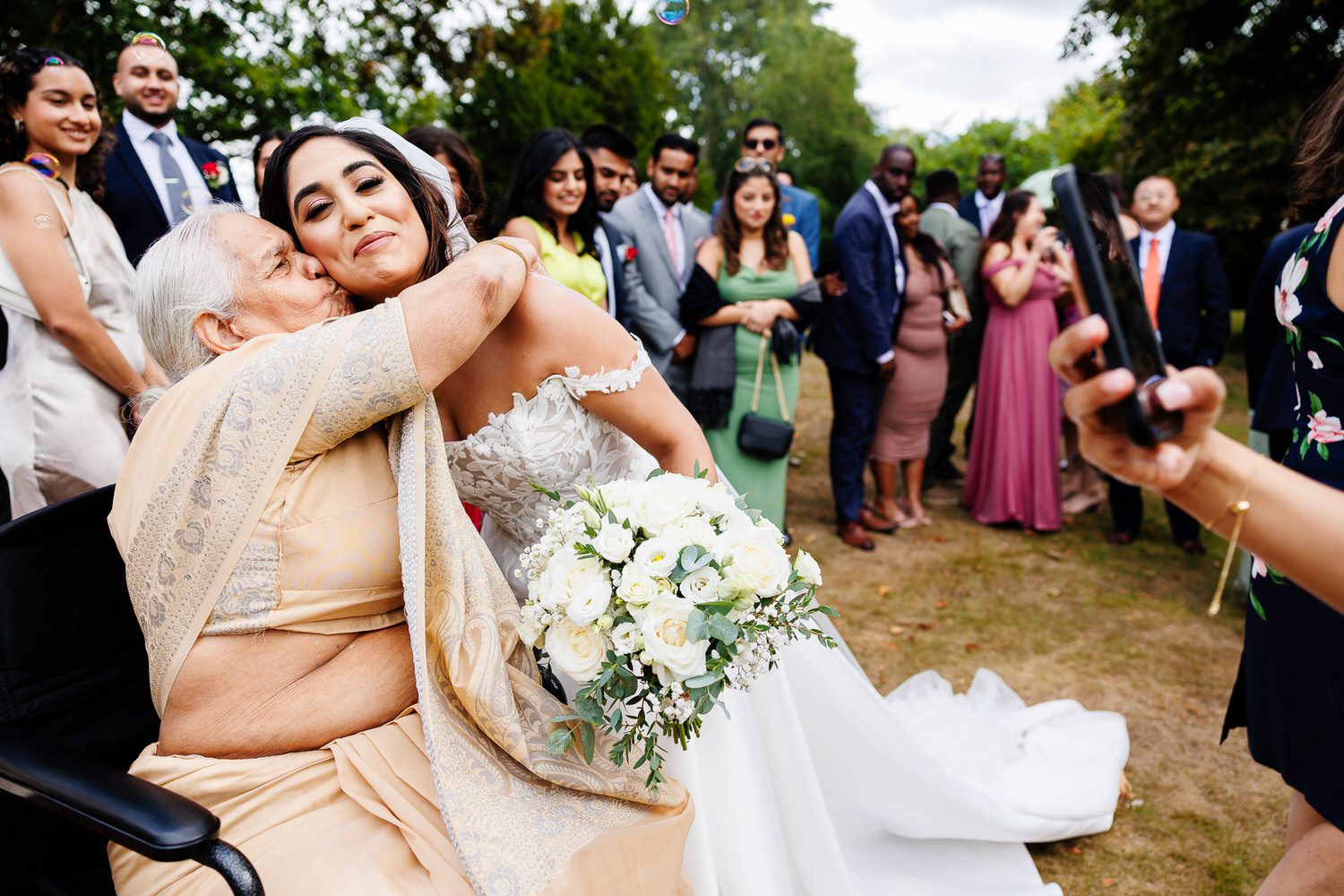 Grandmother kissing bride