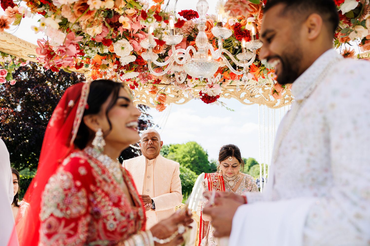 Asian wedding parents inbetween wedding couple