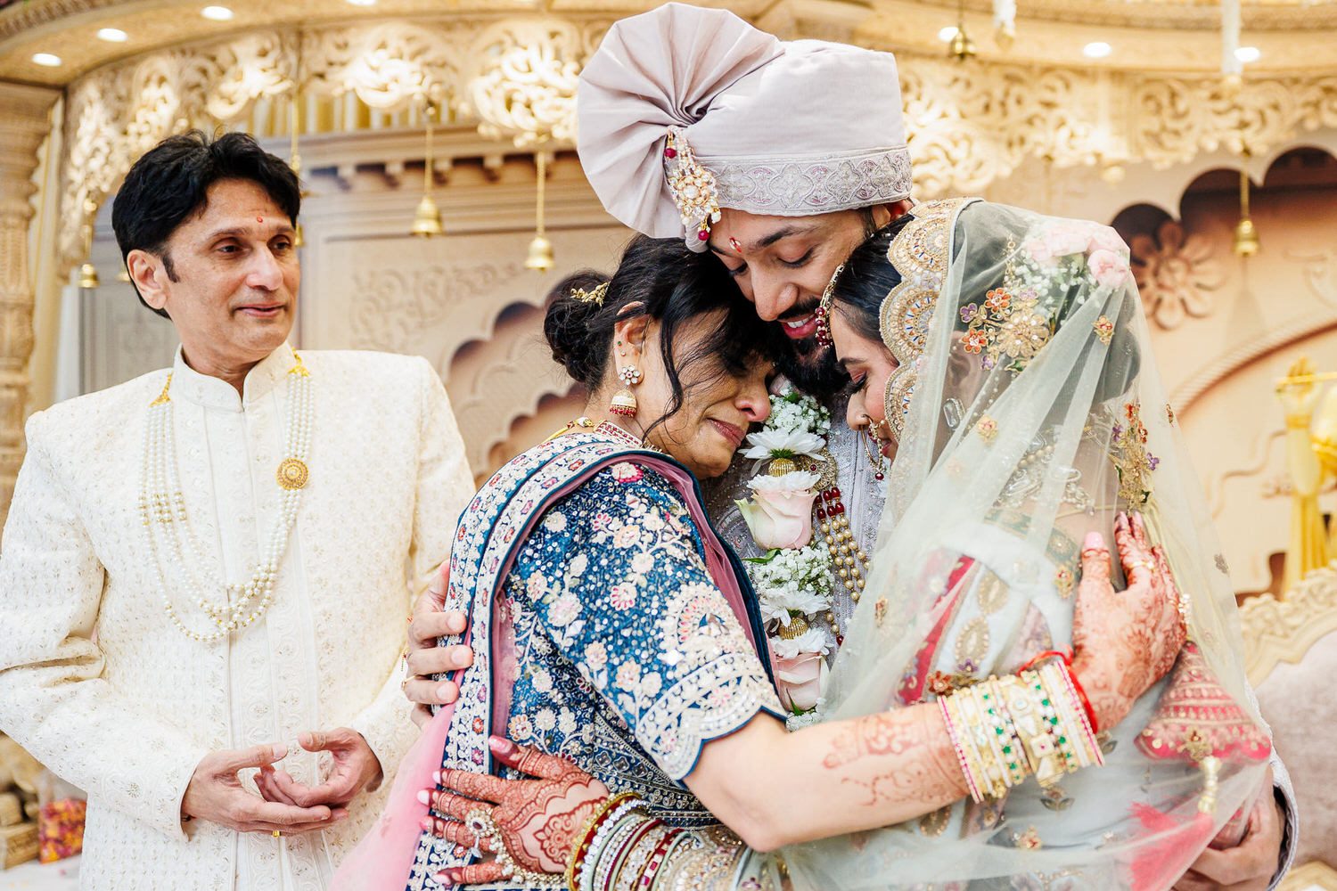 Wedding couple hugging Mother of the bride