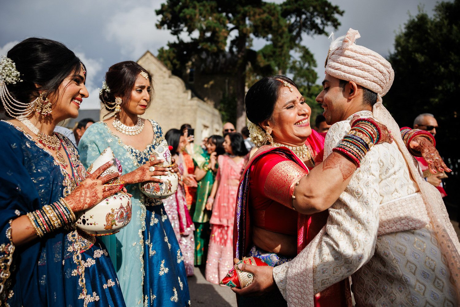 Mother of the bride hugging groom