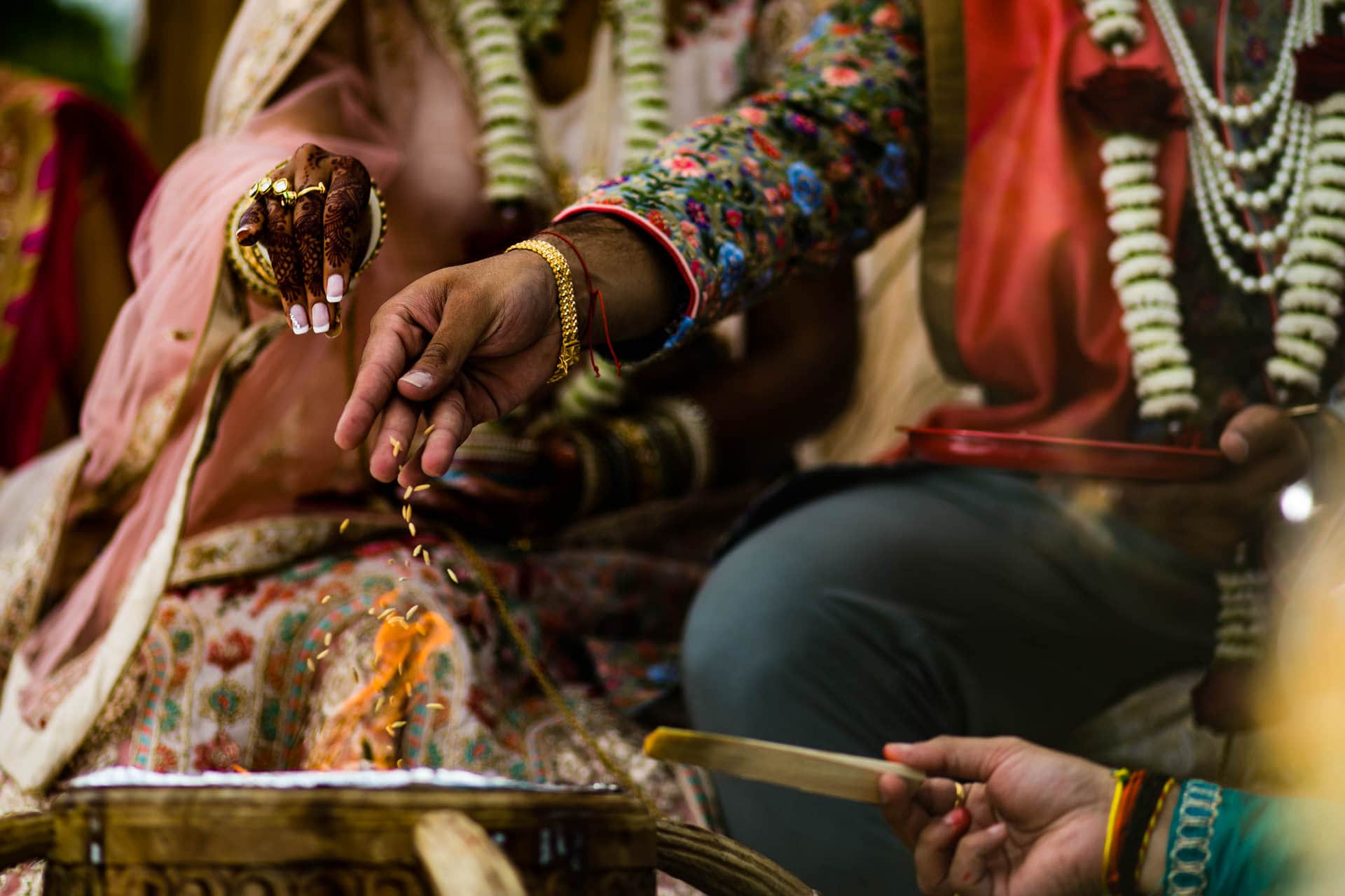 Seeds being thrown into the fire during Mandap ceremony