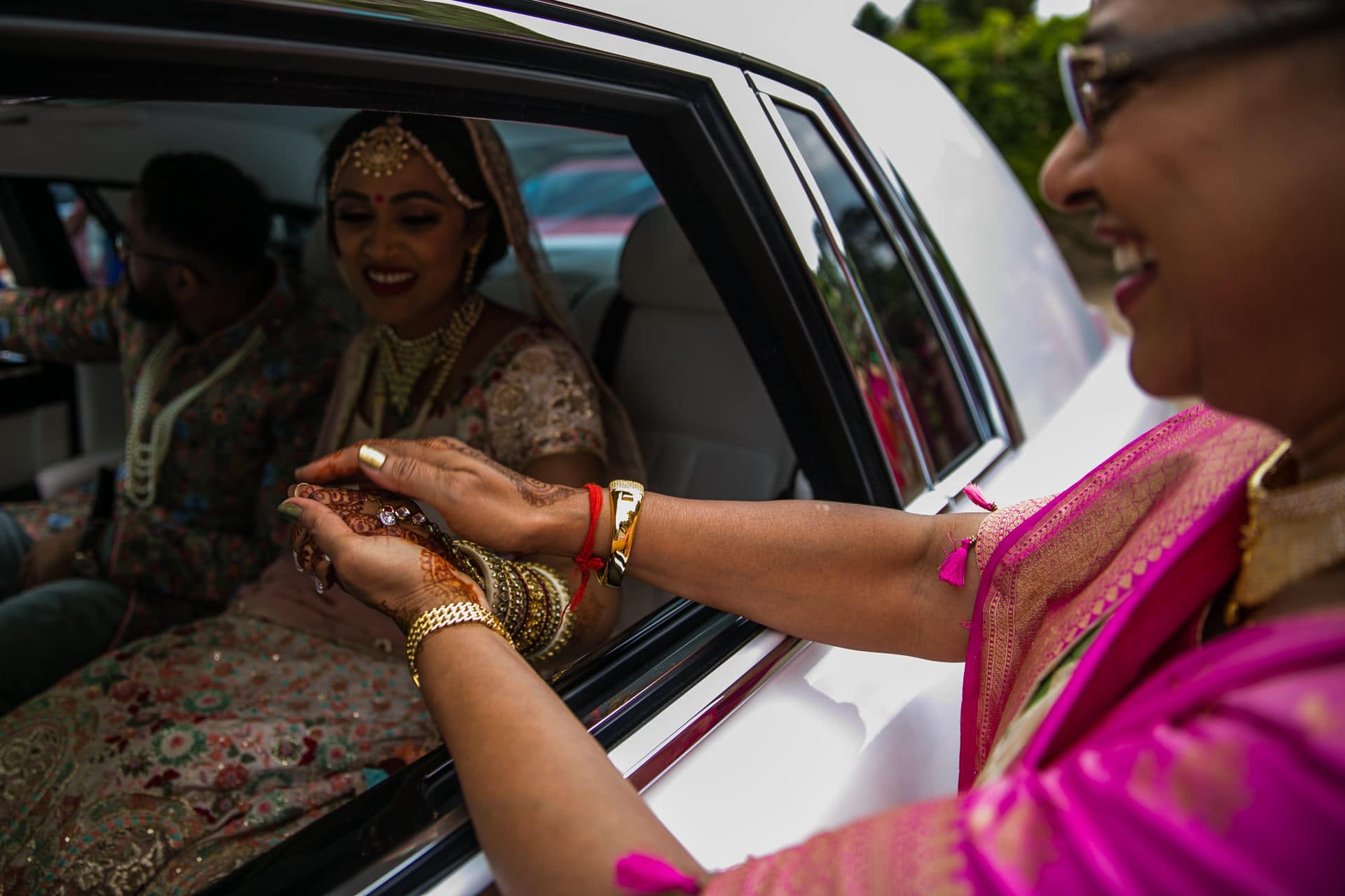 Mother of bride holding brides hands
