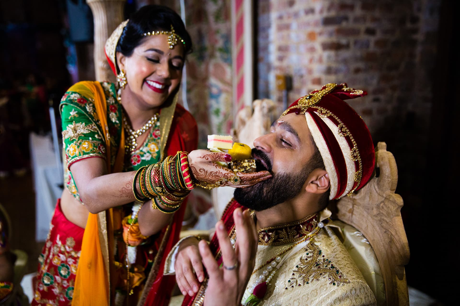 Bride feeding groom sweets