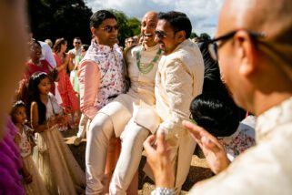 Wedding groom being lifted
