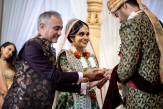 Groom handing bride's hand away in Marriage