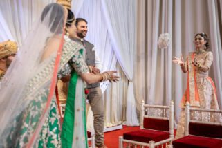 Bride throwing flowers during Hindu wedding