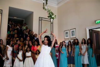 Bride throwing bouquet at Langham hotel wedding