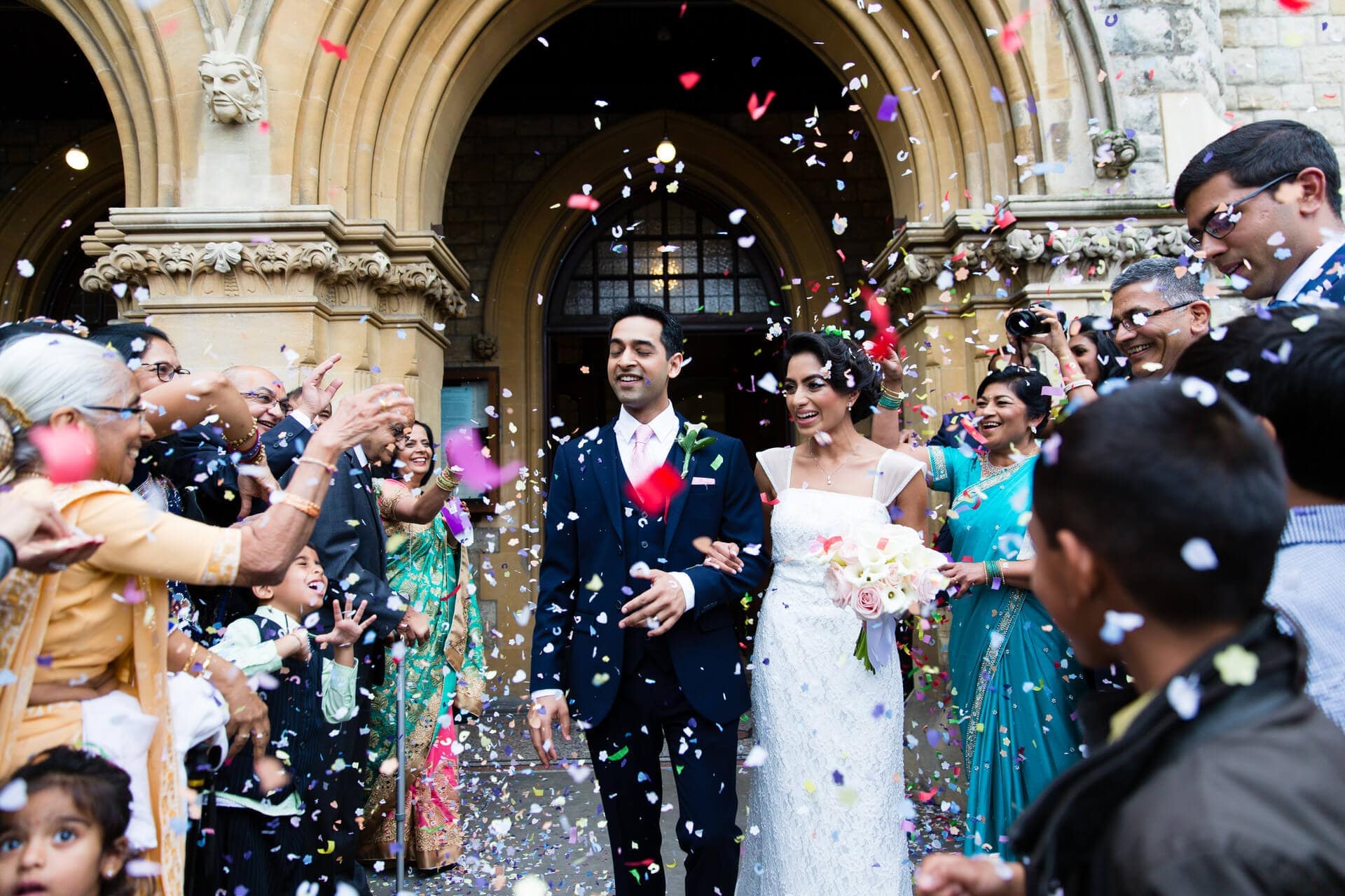 Confetti being thrown at the bride and groom