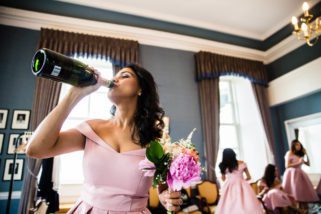 Bridesmaid drinking champagne from the bottle