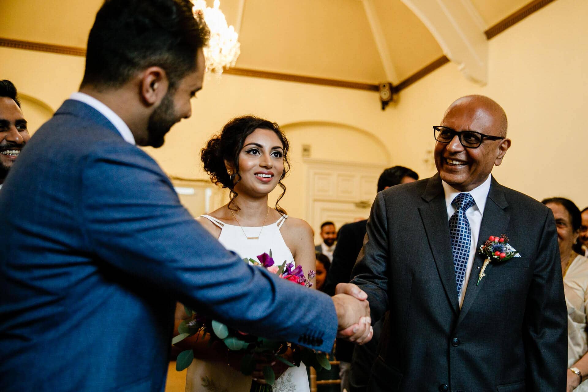 Father of the bride shaking groom's hand