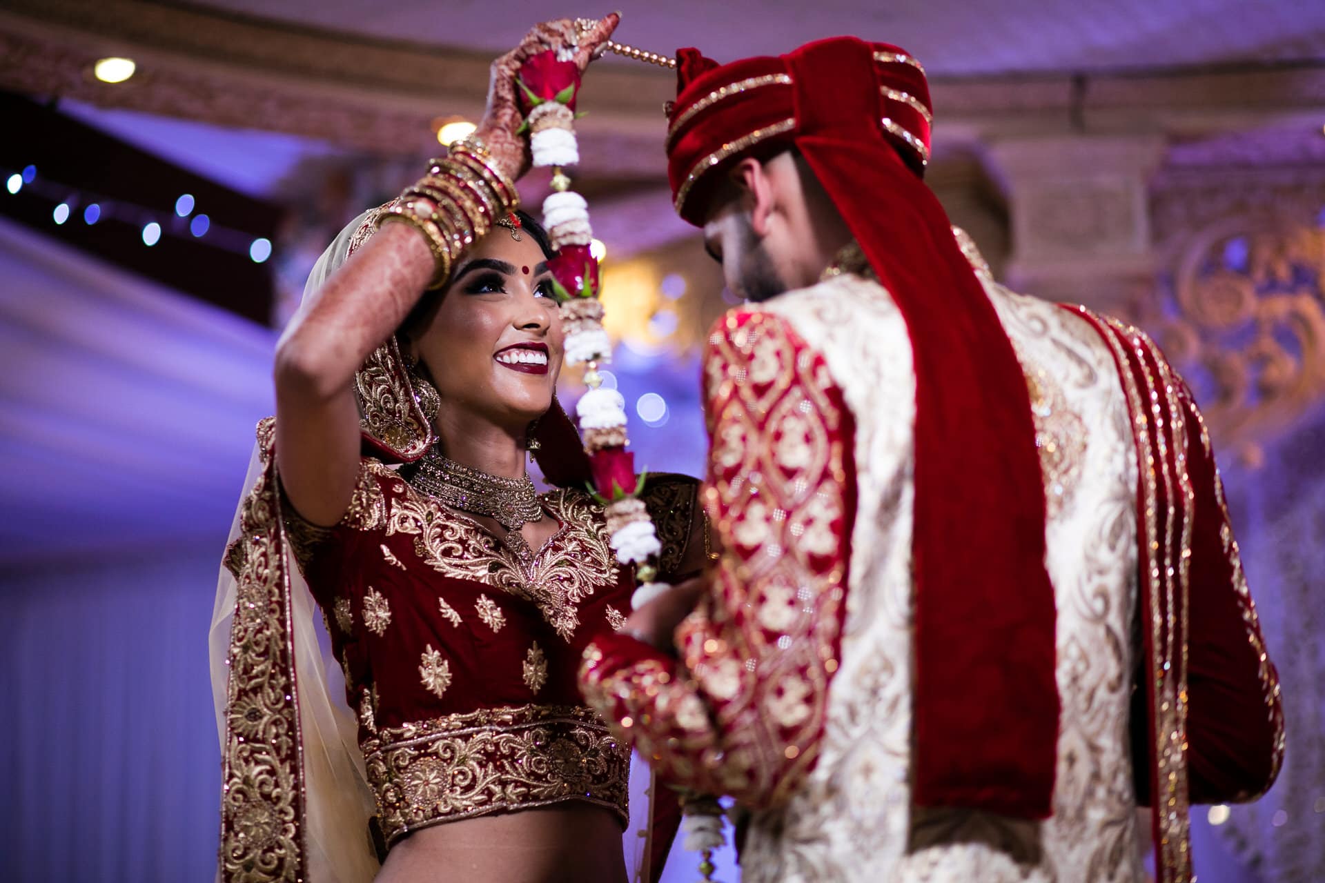 Bride garlanding groom