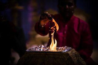 Milan Mehta pouring Ghee into the fire during Hindu Wedding ceremony