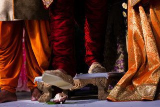 Groom stepping on Clay pot during Hindu Wedding