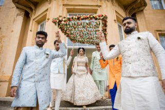Hindu wedding bride walking with her brothers