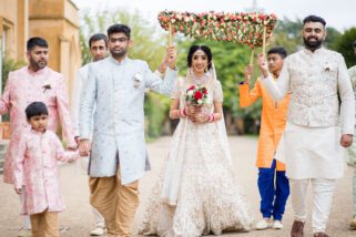 Hindu wedding bride walking with her brothers