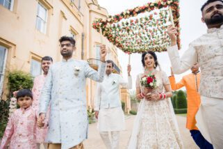 Hindu wedding bride walking with her brothers