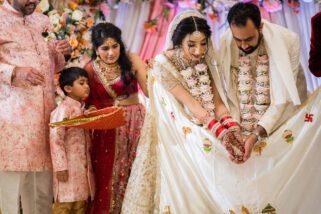 Bride and groom feeding the fire during mandap ceremony
