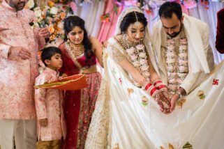 Bride and groom feeding the fire during mandap ceremony