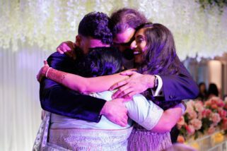 Family hugging at wedding