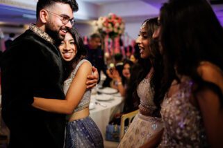 Family hugging at wedding