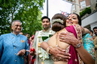 Mothers of Bride and Groom hugging