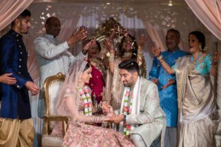 Bride and groom being showered by flowers