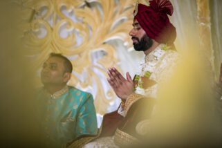 Asian wedding groom praying