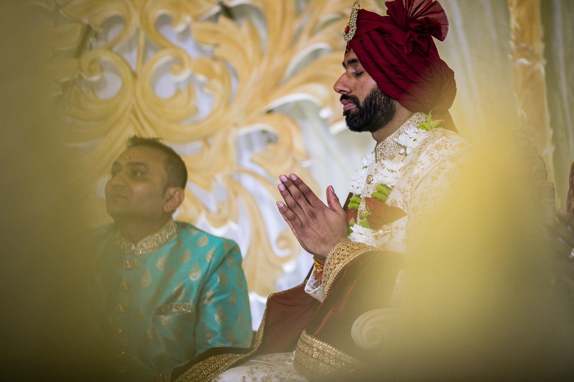 Asian wedding groom praying