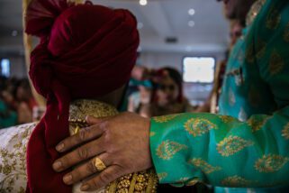 Father of the bride's hands on groom's shoulders