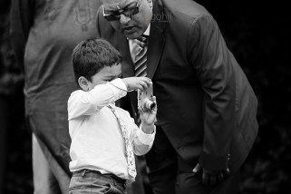 Boy taking photograph at wedding