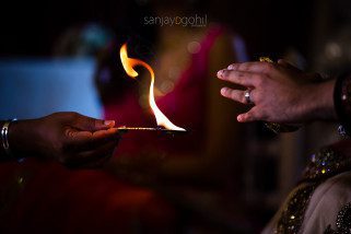 Closeup of hands and flame during Hindu Wedding ceremony