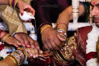 Closeup of water bring poured during Hindu wedding ceremony