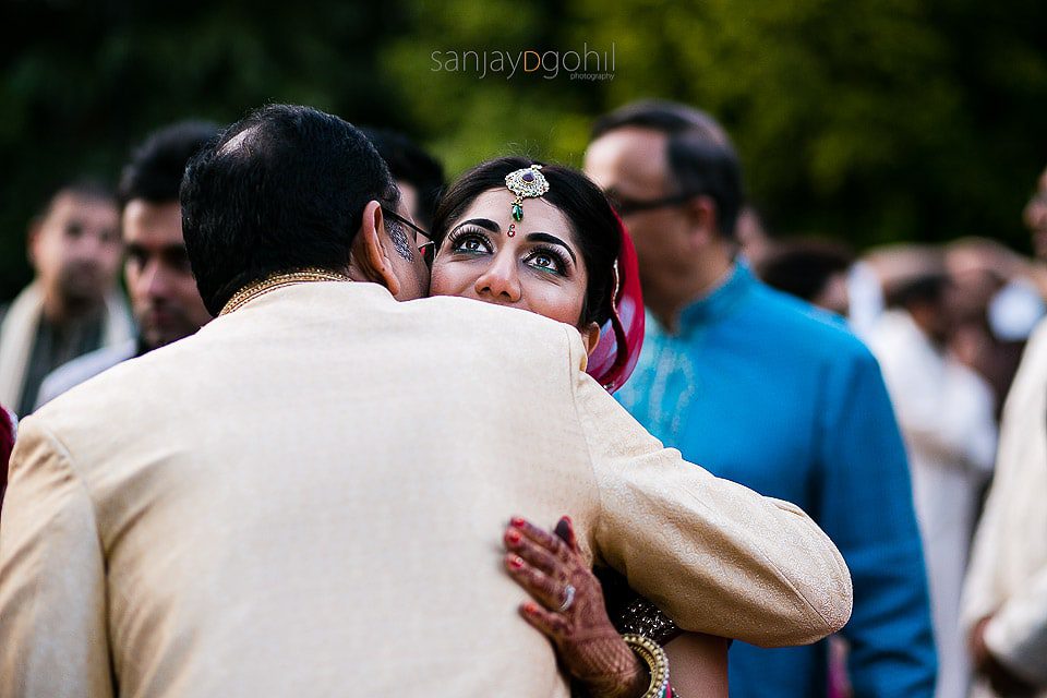 Bride hugging guest during vidhai