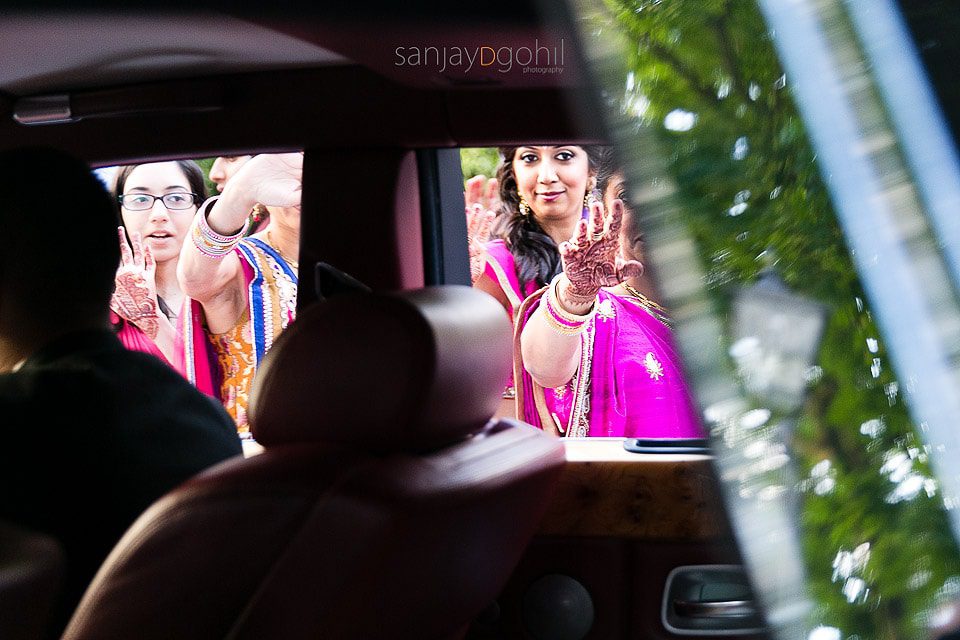 Guest waving goodbye through car window