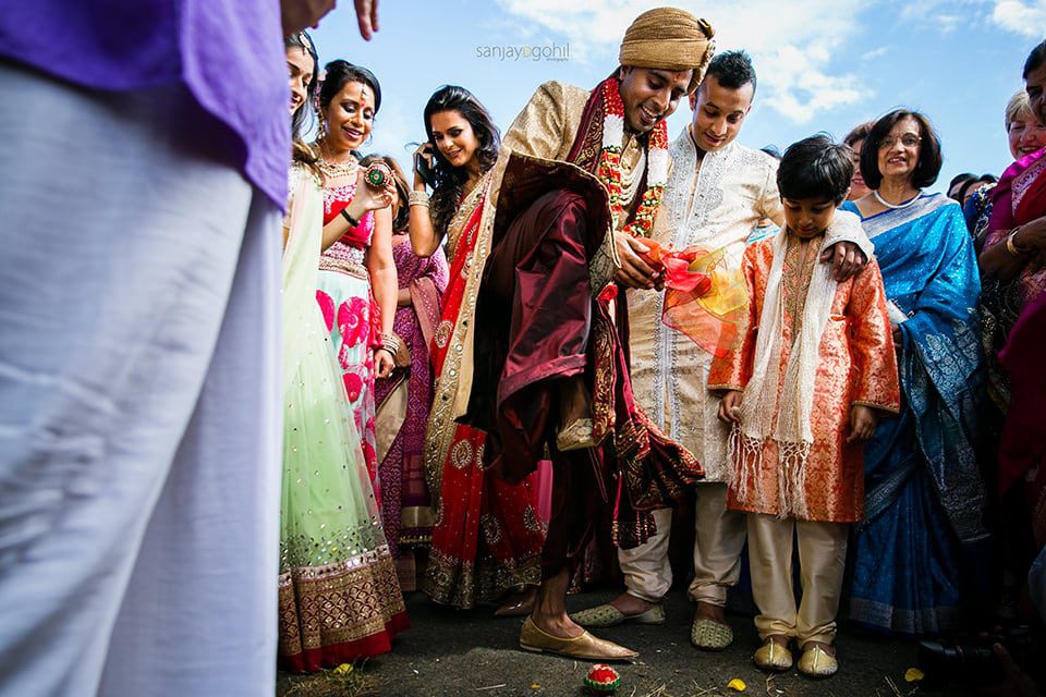 Groom crushing clay pot during wedding ceremony