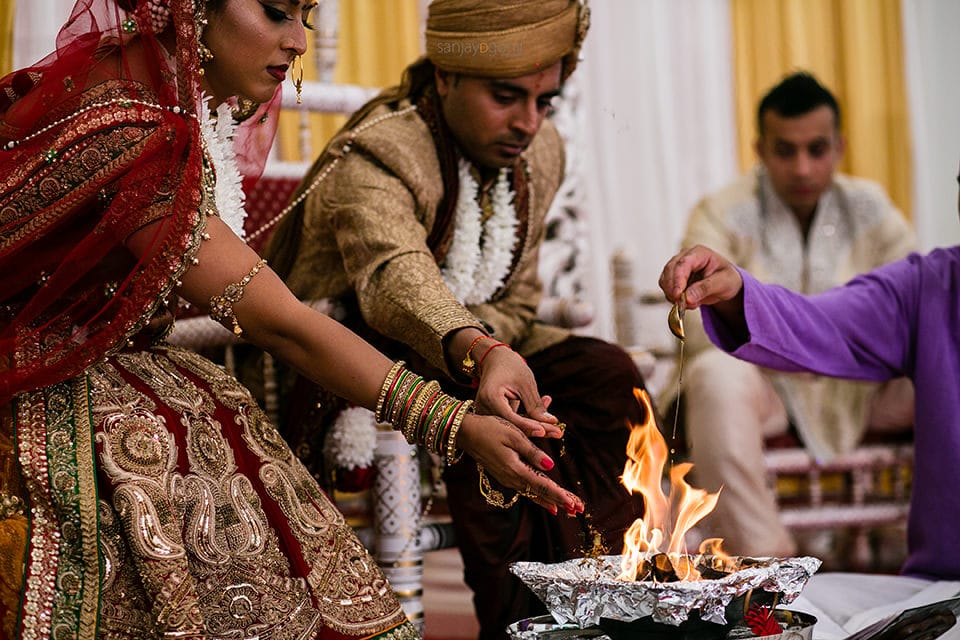 Seeds being poured into the fire during Hindu Weddnig