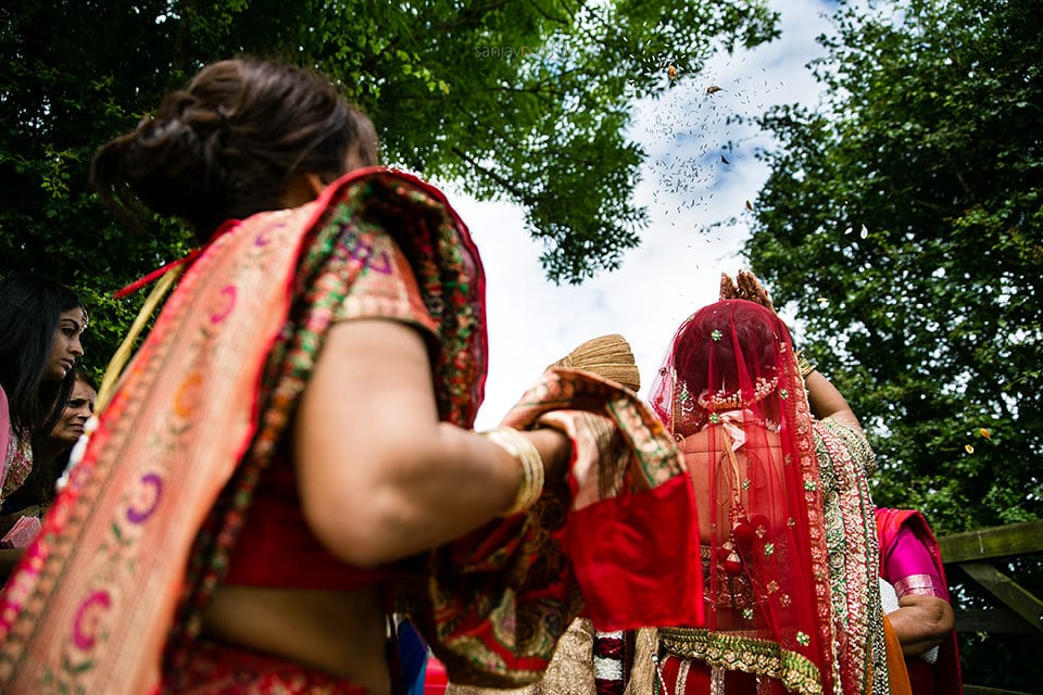 Hindu Bride throwing rice as she leaves