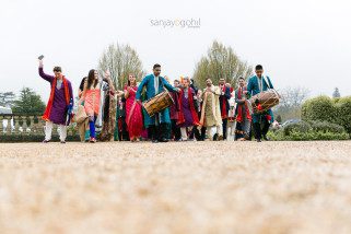 Groom's wedding party arrival with dhol players