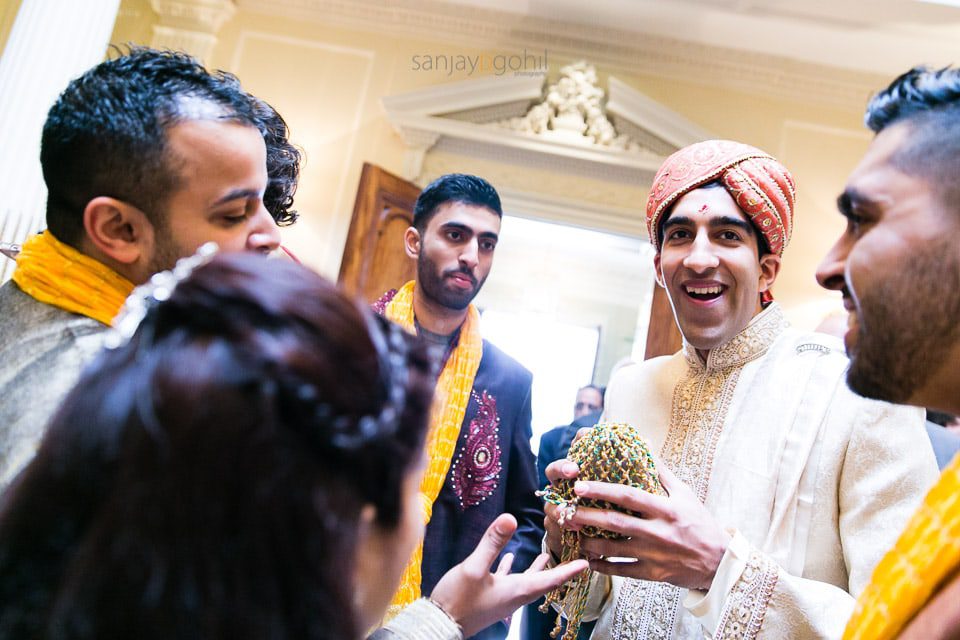 Asian Wedding groom smiling indside hedsor house