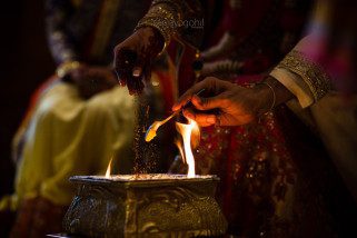 Ghee and seeds being poured into the fire
