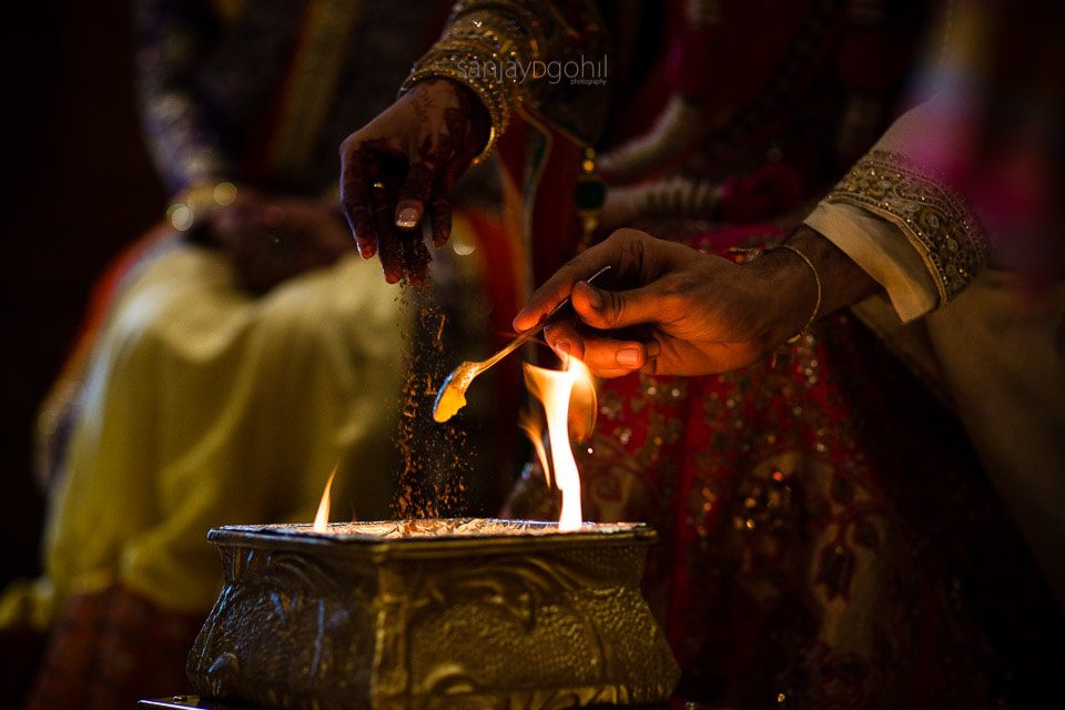 Ghee and seeds being poured into the fire 