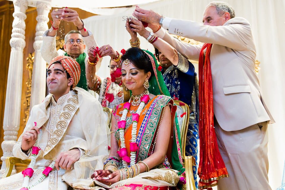 Bride and groom's parents blessing married couple