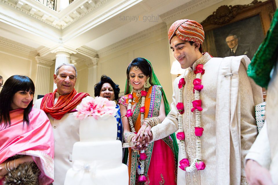 Bride and groom cutting cake