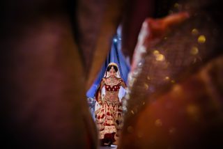 Asian wedding bride walking into the mandap