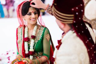 Groom placing sindoor onto bride