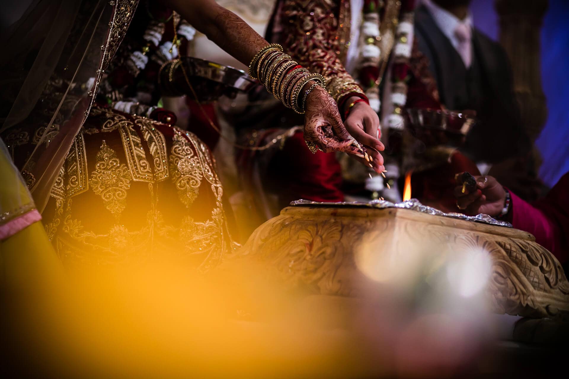 Seeds being poured into the fire during Hindu wedding