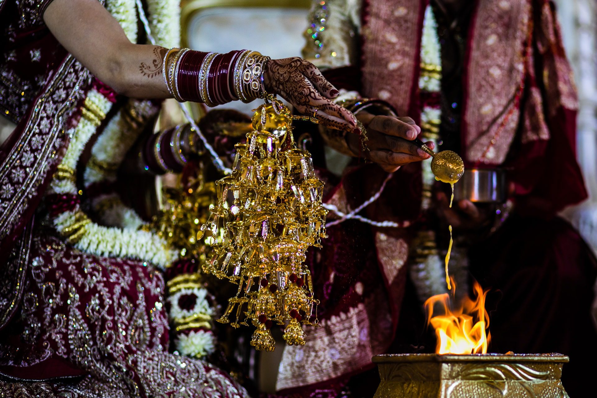 Ghee and seeds being poured into the fire during mandap ceremony